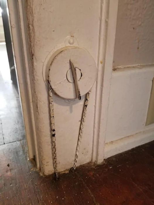 What is this dial with a chain that goes into the floor of this old house?